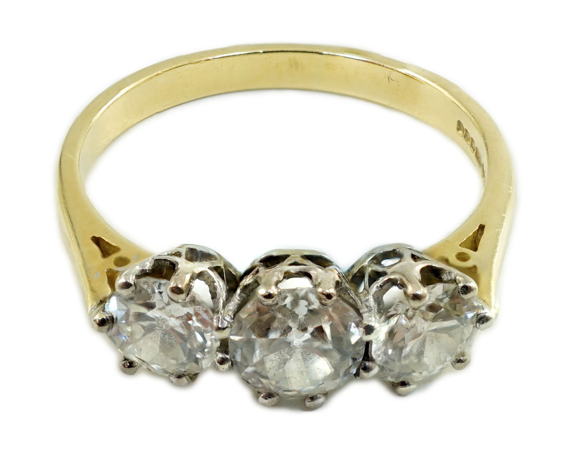 A modern 18ct gold and three stone diamond set ring